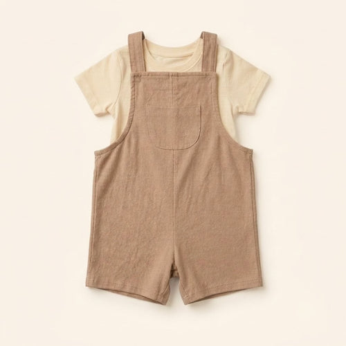 Oat-beige cotton dungaree over a white tee, laid flat