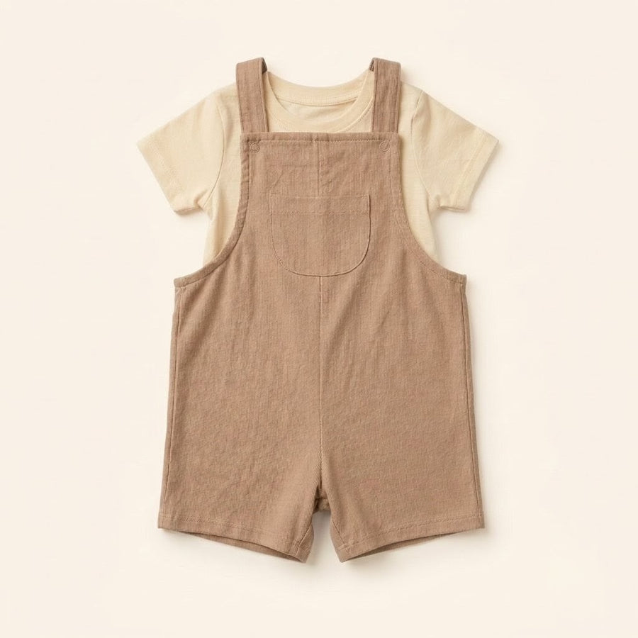 Oat-beige cotton dungaree over a white tee, laid flat